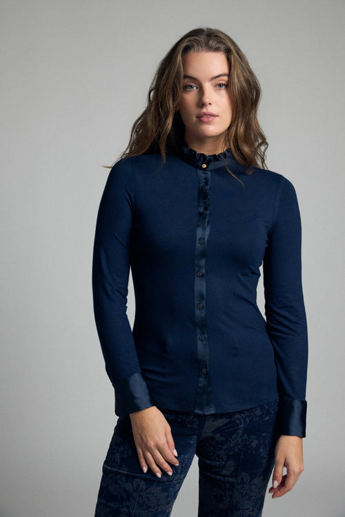 Shop the Bariloche 4007115 Andria Women's Shirt in Navy at Dotique. A fitted jersey shirt with a feminine frill neckline, satin trim and elegant styling for work and special occasions.